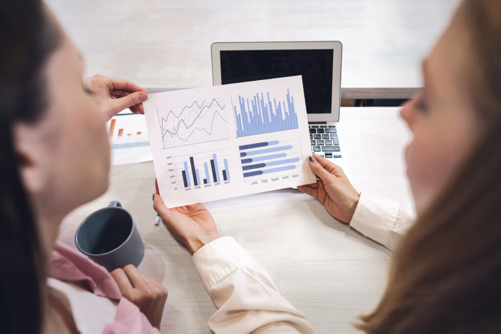 two ladies sitting at a desk discussing B2B SaaS marketing strategies